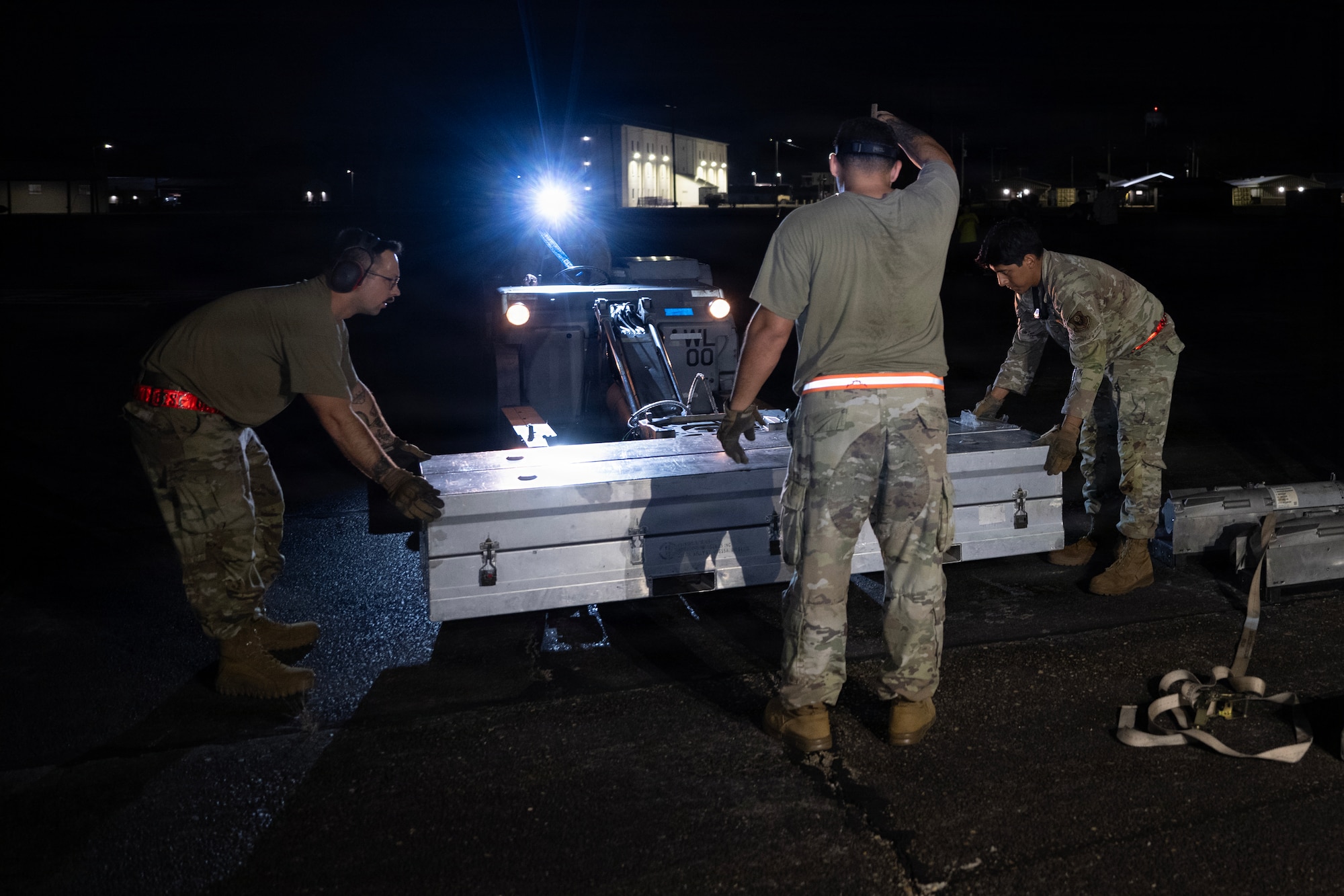U.S. Air Force munitions systems specialists assigned to the 1st Special Operations Wing position assets for loading during an Ammo Advanced Performance Experience at Eglin Range, Florida, Nov. 5, 2025.