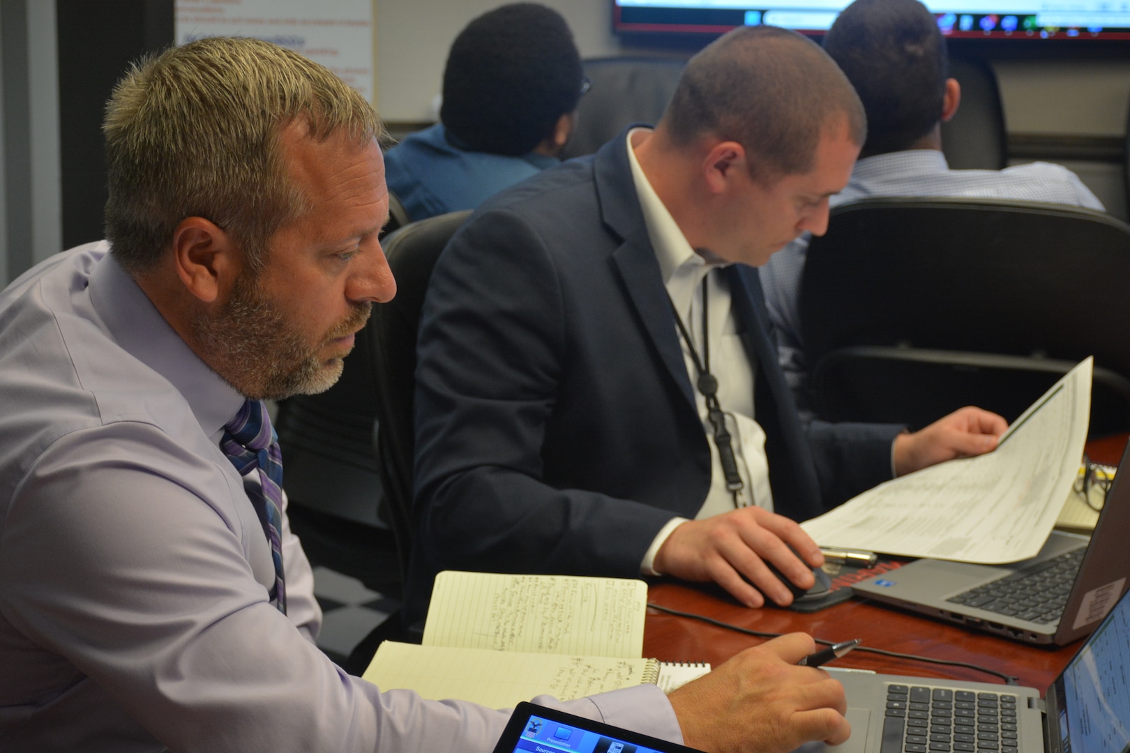 Two people review documents during a working group.