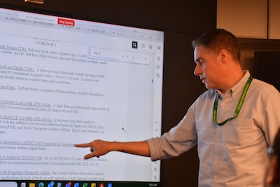 Man reviews document on screen.