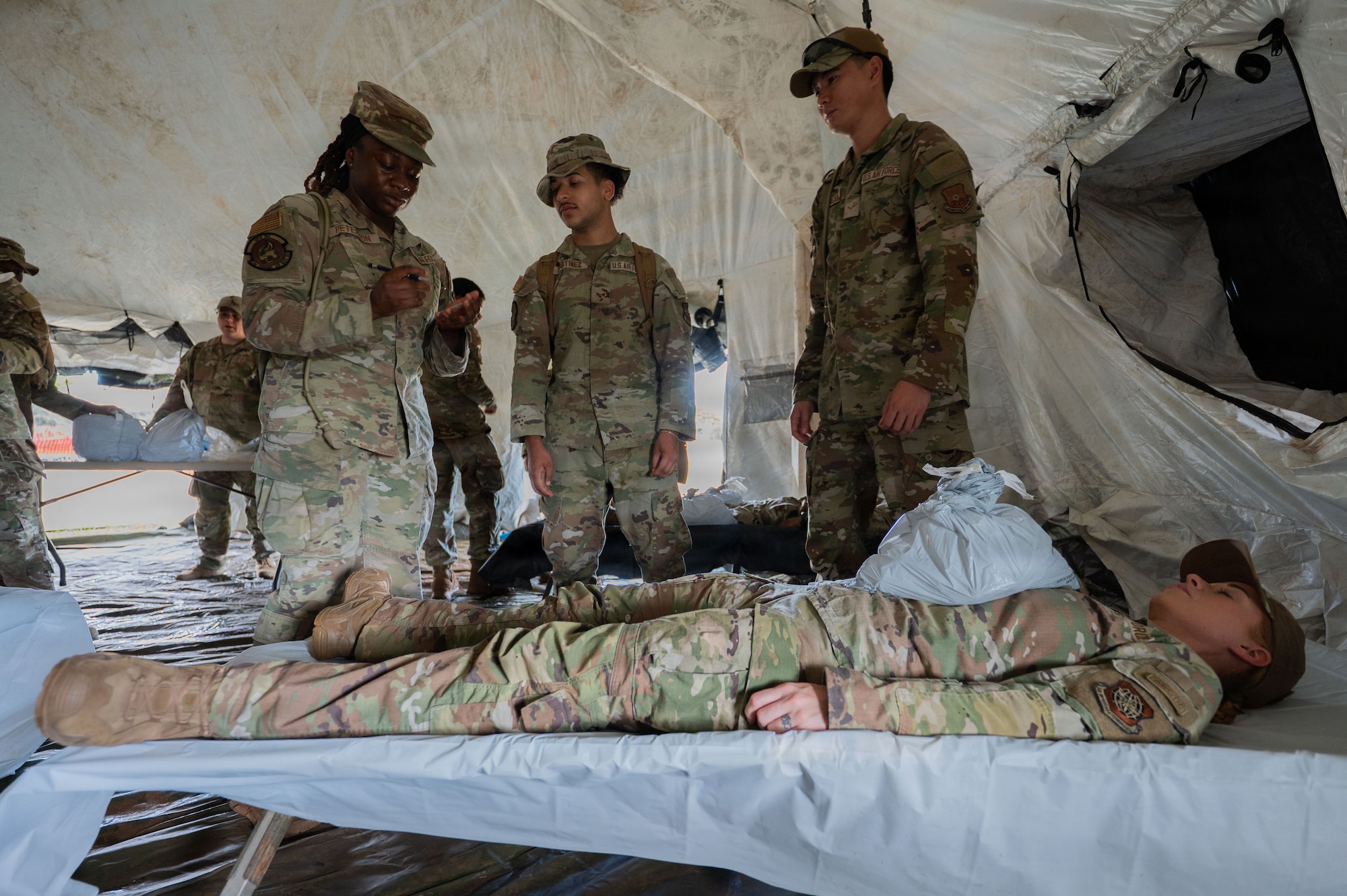 U.S. Airmen assigned to the 21st Combat Air Base Squadron train in an expeditionary Mortuary Affairs Center during Joint Pacific Multinational Readiness Center 26-01 at Schofield Barracks, Hawaii, Nov. 6, 2025. The training prepared Airmen to execute the entire mortuary process in austere environments while operating as part of the Joint and multinational force in the Indo-Pacific. (U.S. Air Force photo by Senior Airman Alondra Cristobal Hernandez)