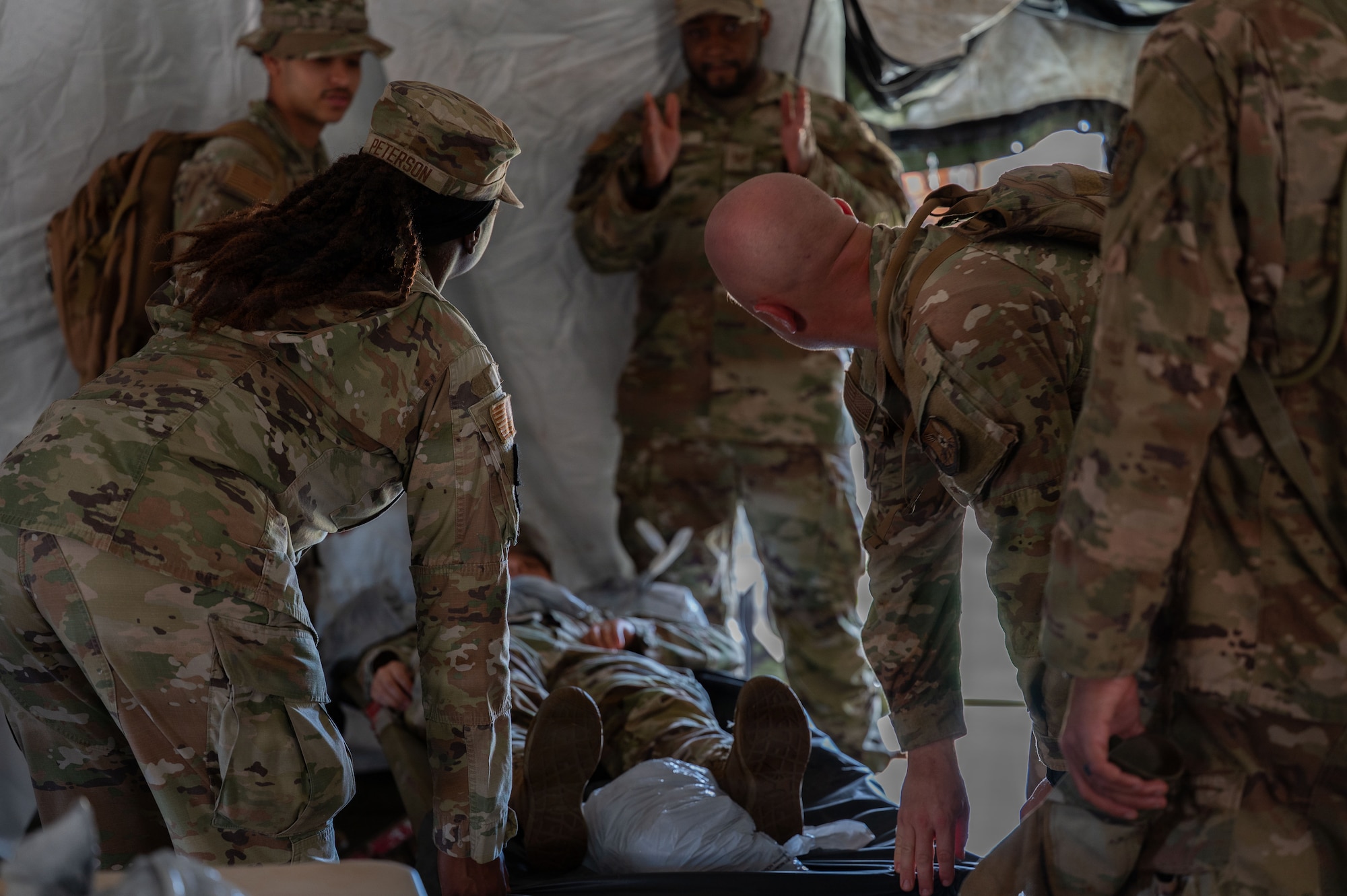 U.S. Airmen assigned to the 21st Combat Air Base Squadron train in an expeditionary Mortuary Affairs Center during Joint Pacific Multinational Readiness Center 26-01 at Schofield Barracks, Hawaii, Nov. 6, 2025. The training prepared Airmen to execute the entire mortuary process in austere environments while operating as part of the Joint and multinational force in the Indo-Pacific. (U.S. Air Force photo by Senior Airman Alondra Cristobal Hernandez)