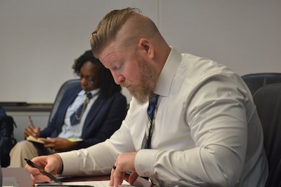 Man reviews notes during working group.