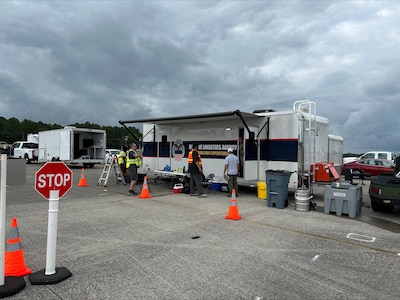 People stand by a trailer.