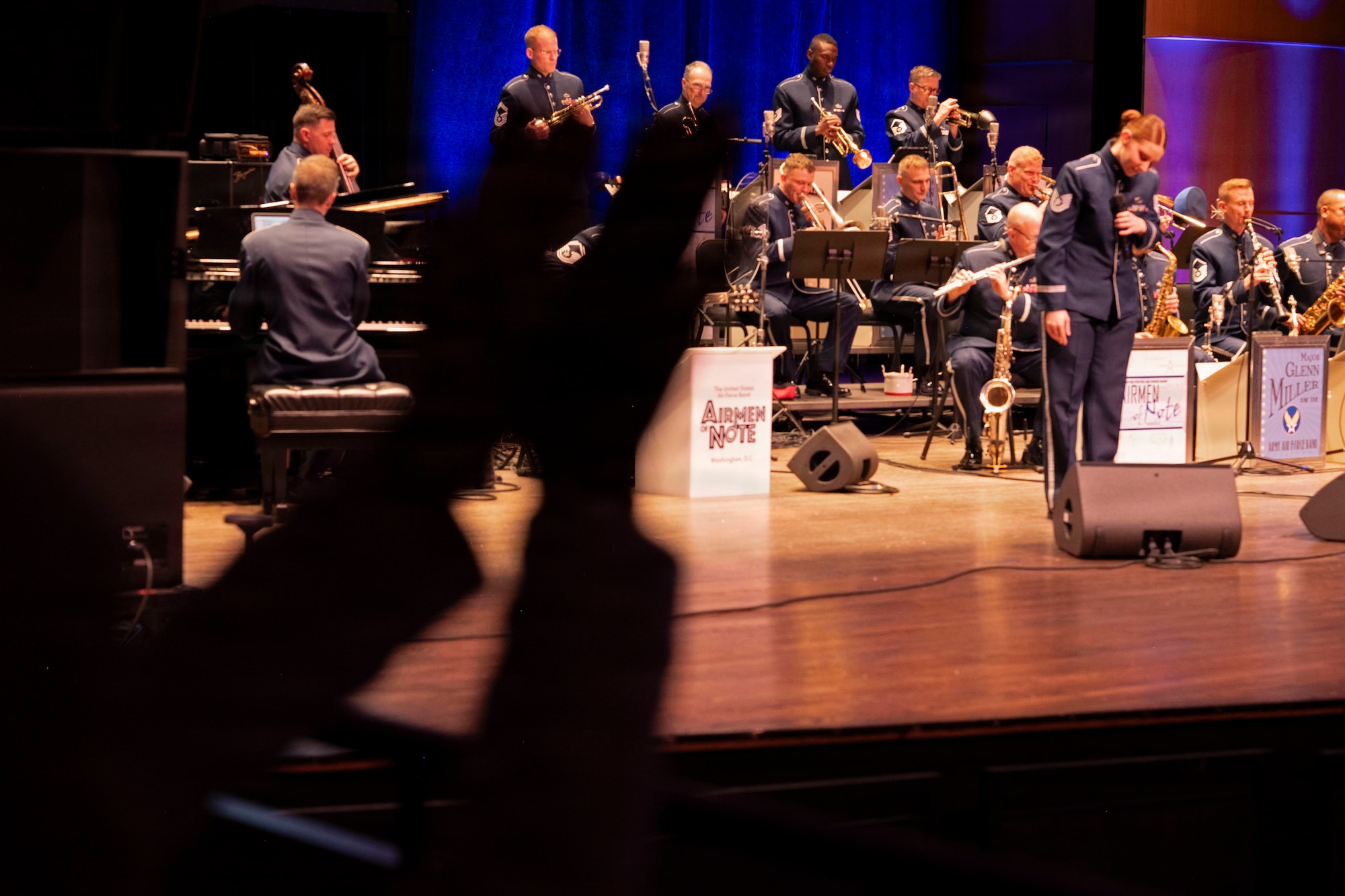 U.S. Air Force Tech. Sgt. Clara Campbell, vocalist for the U.S. Air Force Band’s Airmen of Note, takes a bow during the group’s 75th anniversary concert in Alexandria, Va., Sept. 26, 2025. The ensemble continued its legacy during the concert by honoring veterans, inspiring the audience, and connecting with the community through music. (U.S. Air Force photo by Staff Sgt. Jordan Powell)