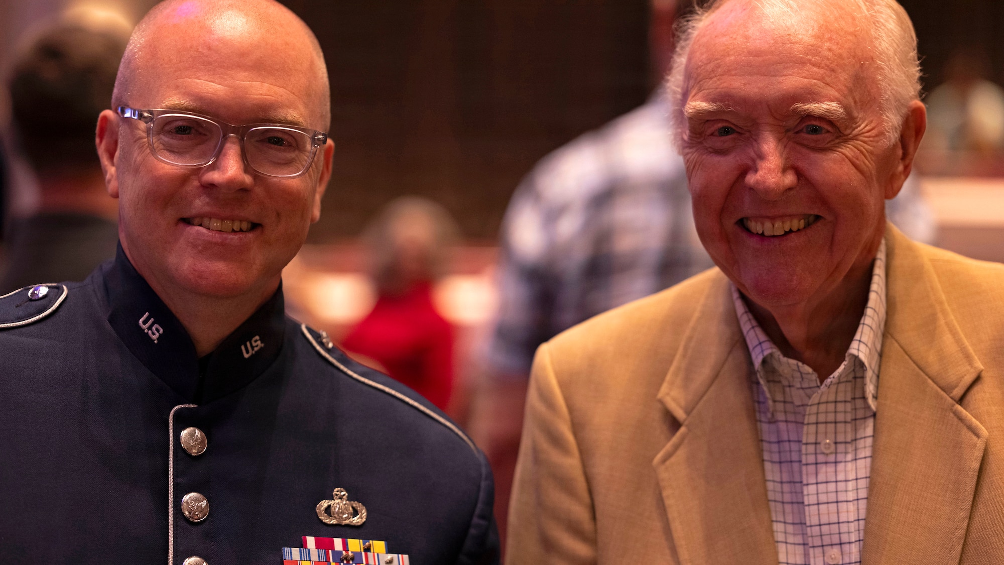 U.S. Air Force Master Sgt. Tedd C. Baker, tenor saxophonist for the U.S. Air Force Band’s Airmen of Note, smiles with his father, Wayne Baker, after playing in the band’s 75th anniversary concert in Alexandria, Va., Sept. 26, 2025. Not a musician himself, Wayne joked he funded his son’s expensive musical start. Baker has played on multiple Air Force recordings in his nearly 25 years with the group and can be heard on critically acclaimed commercial records. (U.S. Air Force photo by Staff Sgt. Jordan Powell)