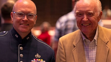 U.S. Air Force Master Sgt. Tedd C. Baker, tenor saxophonist for the U.S. Air Force Band’s Airmen of Note, smiles with his father, Wayne Baker, after playing in the band’s 75th anniversary concert in Alexandria, Va., Sept. 26, 2025. Not a musician himself, Wayne joked he funded his son’s expensive musical start. Baker has played on multiple Air Force recordings in his nearly 25 years with the group and can be heard on critically acclaimed commercial records. (U.S. Air Force photo by Staff Sgt. Jordan Powell)