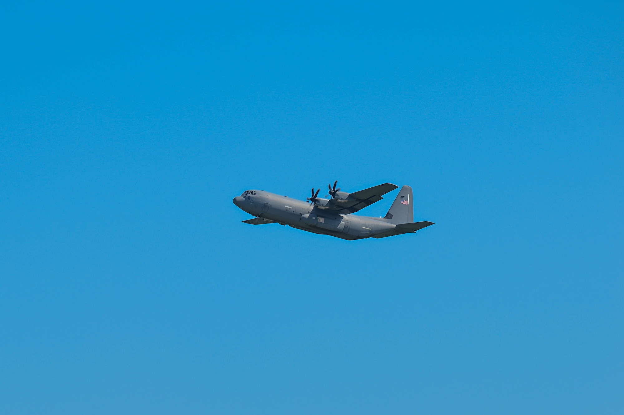 A C-130J aircraft in the air.