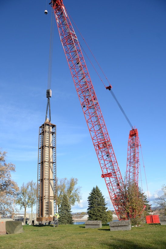 A U.S. Army Corps of Engineers crew lifts the Obelisk from Tribal burial grounds using a red crane in Sault Ste. Marie, Michigan on Nov. 4, 2025.