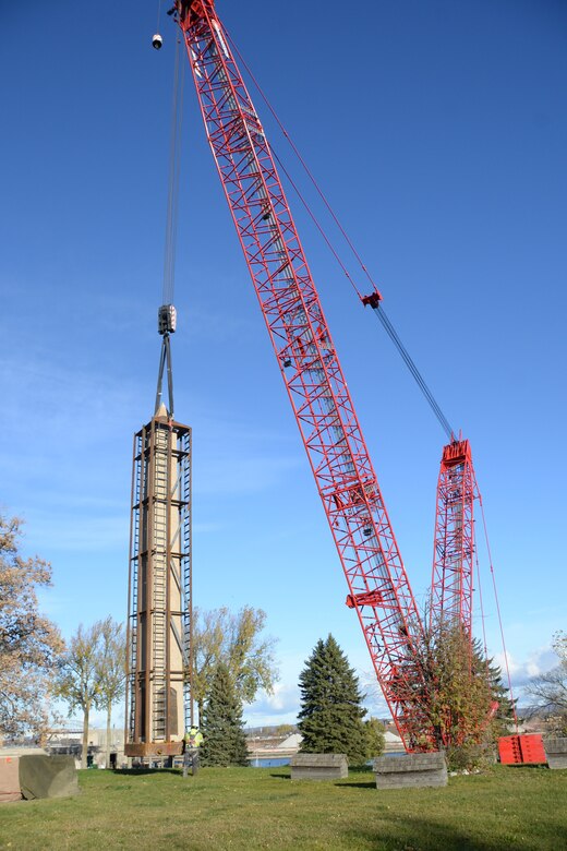 A U.S. Army Corps of Engineers crew lifts the Obelisk from Tribal burial grounds using a red crane in Sault Ste. Marie, Michigan on Nov. 4, 2025.
