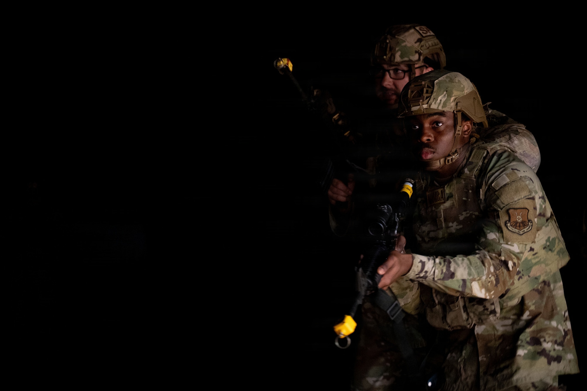U.S. Airmen assigned to the 21st Combat Air Base Squadron prepare to enter a facility as part of Close Quarters Battle training during Joint Pacific Multinational Readiness Center 26-01 at Schofield Barracks, Hawaii, Nov. 6, 2025. These training events prepare the 21st CABS to operate in contested environments, increasing combat survivability and lethality, and enhancing readiness for worldwide missions. (U.S. Air Force photo by Senior Airman Alondra Cristobal Hernandez)