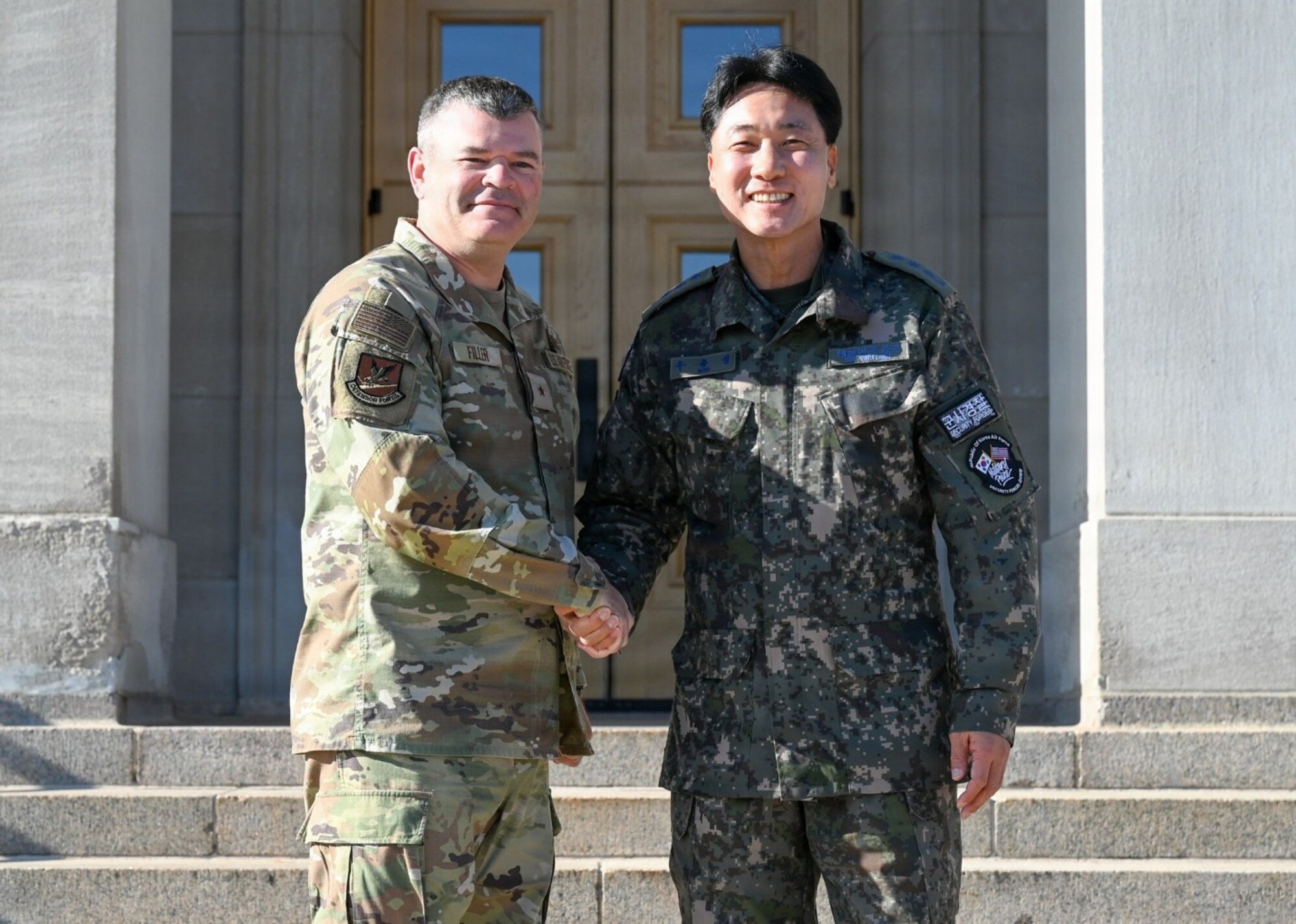 U.S. Air Force Brig. Gen. Brian A. Filler, Director of Security Forces, Deputy Chief of Staff for Logistics, Engineering and Force Protection, poses with Republic of Korea Air Force Col. Jongsung Woo, during a visit to the Pentagon.