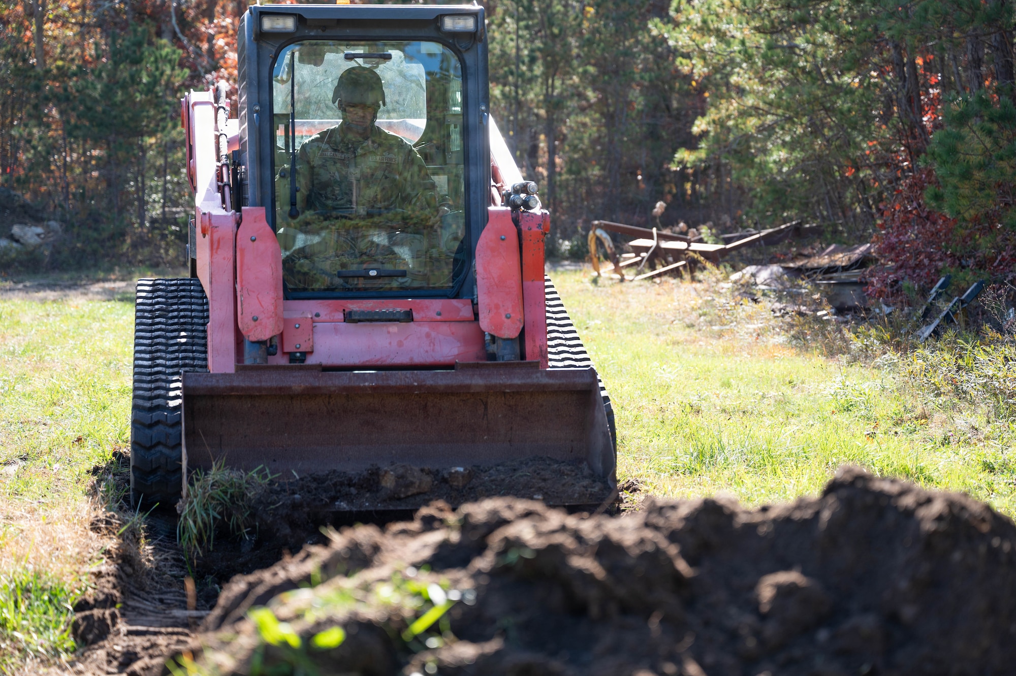 Photo of an Airman operating a front-end loader.