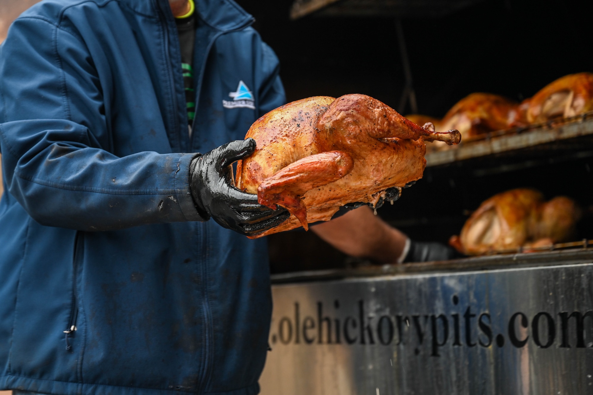 A smoked turkey is being held.