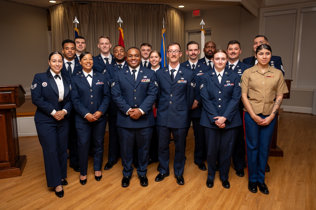 A large group of uniformed men and women pose for a photo.