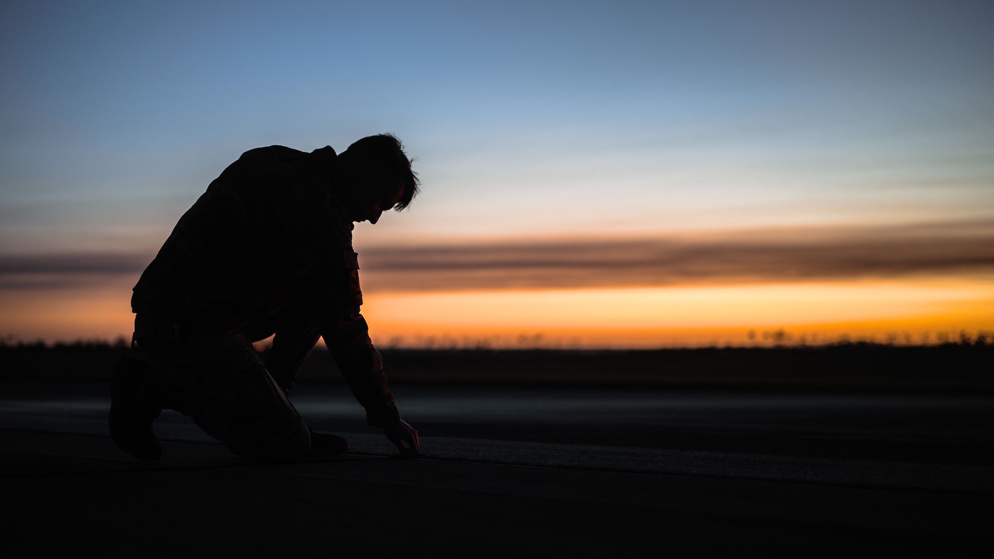 Airman cleans debris