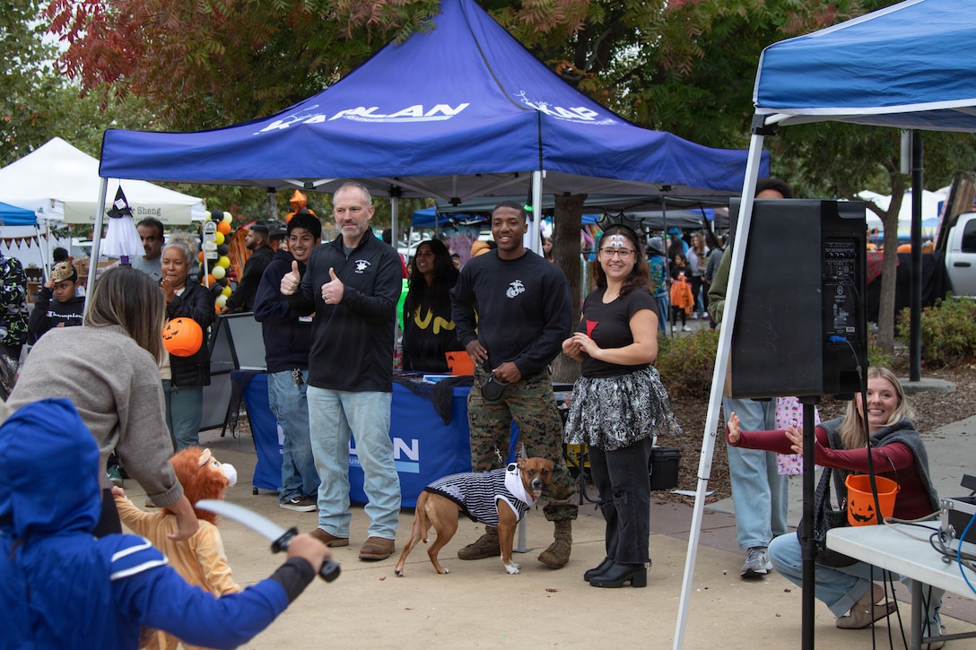 U.S. Marines Corps Staff Sgt. Gabriel Skipper, a canvassing recruiter with Recruiting Sub-Station South Sacramento, Recruiting Station Sacramento, judges a Halloween costume contest during the District 1 Trunk or Treat and Autumn Festival hosted by the Sacramento City Council in Sacramento, California, Oct. 25, 2025. Marines participating in local community events support and bolster their relationships within the community and with local leaders, thus strengthening rapport and awareness between U.S. service members and the communities they serve. (U.S. Marine Corps photo by Staff Sgt. Ryan Harvey)