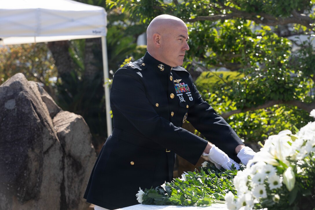 U.S. Marine Corps Col. Kenneth Rossman, the commanding officer of Marine Corps Air Station Iwakuni, and native of Pittsburgh, Pennsylvania, places a flower on a memorial site during a memorial service at MCAS Iwakuni, Japan, Nov. 07, 2025. Japan Maritime Self-Defense Force Fleet Air Wing 31 held an annual memorial ceremony to honor fallen JMSDF sailors who dedicated their lives to protecting Japan. (U.S. Marine Corps photo by Lance Cpl. Siwan Lewis)