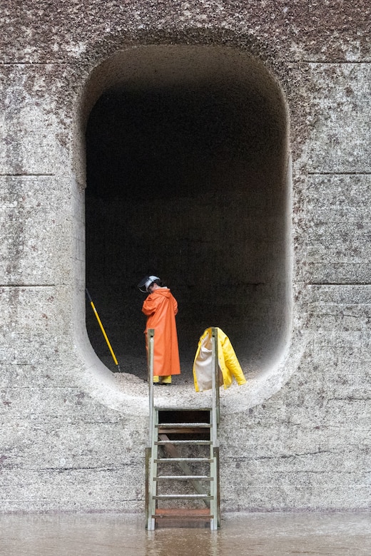 The large lock at at the Hiram M. Chittenden Locks contains two culverts, each about 800 feet long, 8 feet wide and 14 feet tall. Each year, Seattle District volunteers scrape barnacles along the length of each culvert, preventing injury to migrating fish.