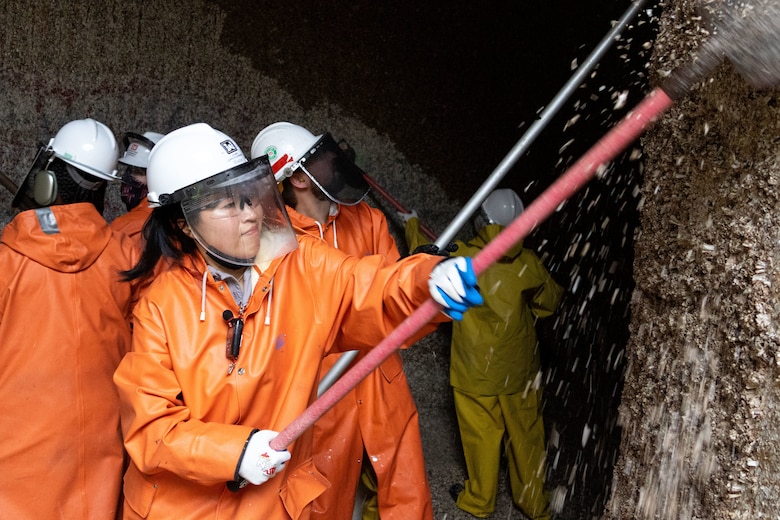 Seattle District teammates scrape barnacles from one of the large lock culverts at at the Hiram M. Chittenden Locks, an annual event which prevents injury to migrating fish.