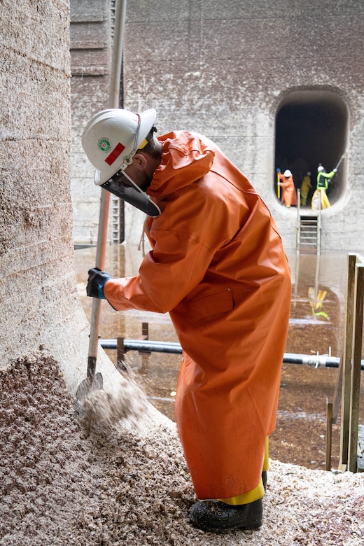 A Seattle District employee scrapes barnacles from one of the large lock culverts at at the Hiram M. Chittenden Locks. Each year, juvenile salmon make their way through the Locks on their journey to Puget Sound, and the sharp barnacles along the tunnels can injure passing fish—including ESA-listed salmonids like Chinook and steelhead.