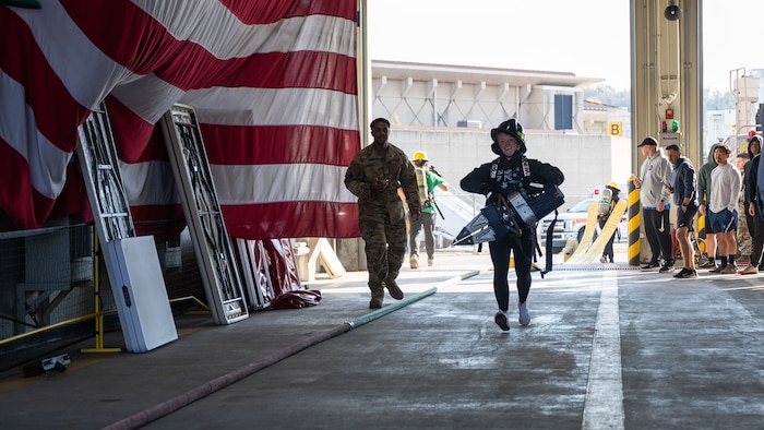U.S. Air Force Staff Sgt. Cashley Redd, center, 51st Civil Engineer Squadron emergency management craftsman, participates in a team building workout at Osan Air Base, Republic of Korea, Nov. 18, 2025. By connecting Airmen across CE fields, the Haetae Leadership Academy helped develop resilient leaders who understand how their roles contribute to combat airpower generation. (U.S. Air Force photo by Senior Airman Rome Bowermaster)