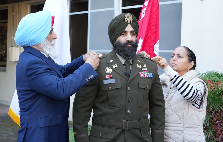 Sukhbir Singh, left, and Jasvir Kaur, far right, pin the rank of Lt. Col. on their son, newly promoted U.S. Army Lt. Col. Simratpal "Simmer" Singh, U.S. Army Corps of Engineers - Japan Engineer District deputy commander, during his promotion ceremony at the District headquarters on Camp Zama, Japan, Nov. 26th, 2025.