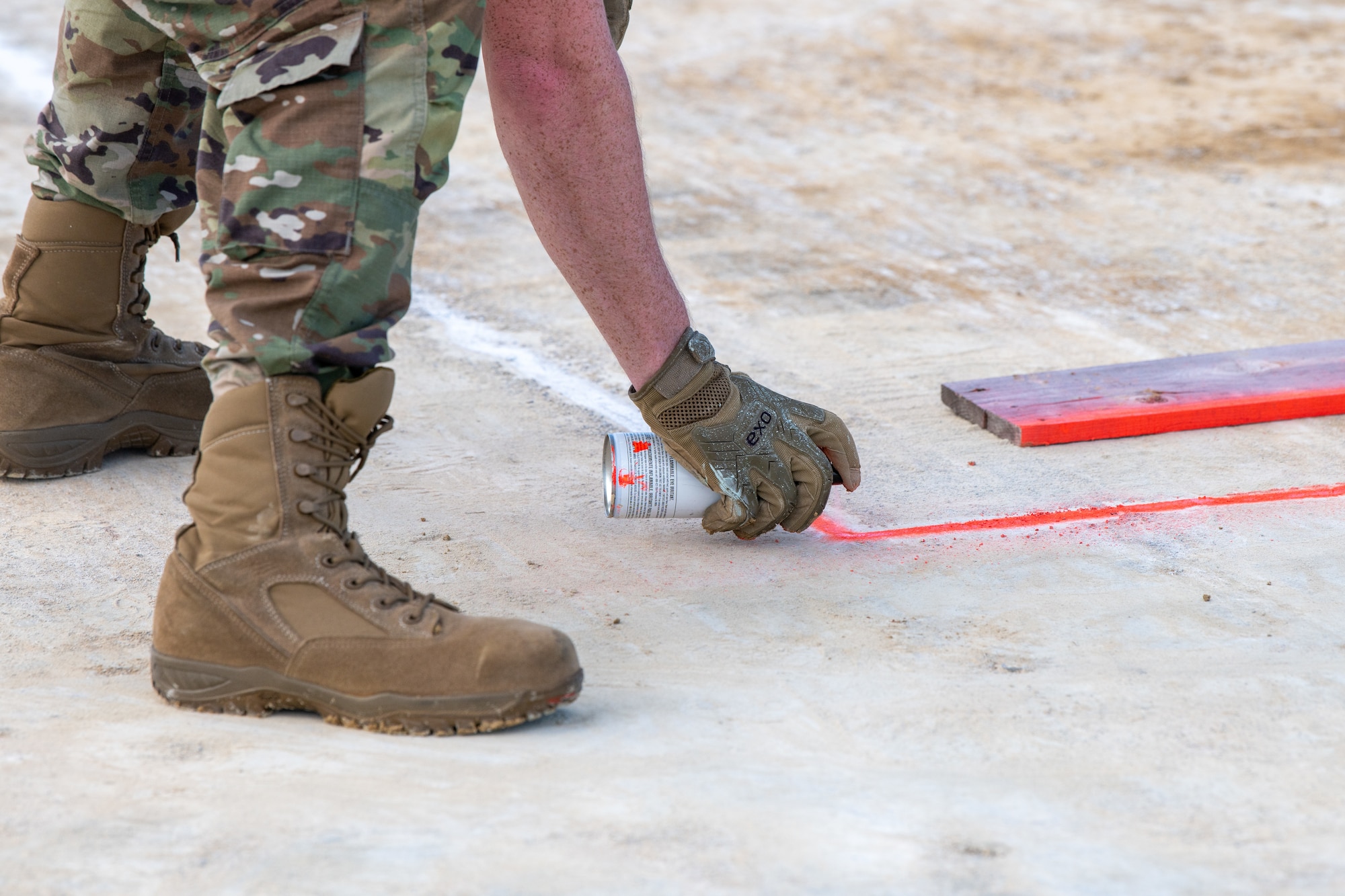 U.S. Air Force Staff Sgt. Brandon Kinder, 18th Civil Engineer Squadron construction inspector, measures the dimensions of a simulated crater during a rapid airfield damage repair exercise in support of base-wide readiness exercise BH 26-1 at Kadena Air Base, Japan, Nov. 6, 2025. By simulating damage to a runway, Airmen practiced the coordination and technical expertise required to sustain flight aircraft operations across the Indo-Pacific. (U.S. Air Force photo by Airman 1st Class Francisco Huerta)