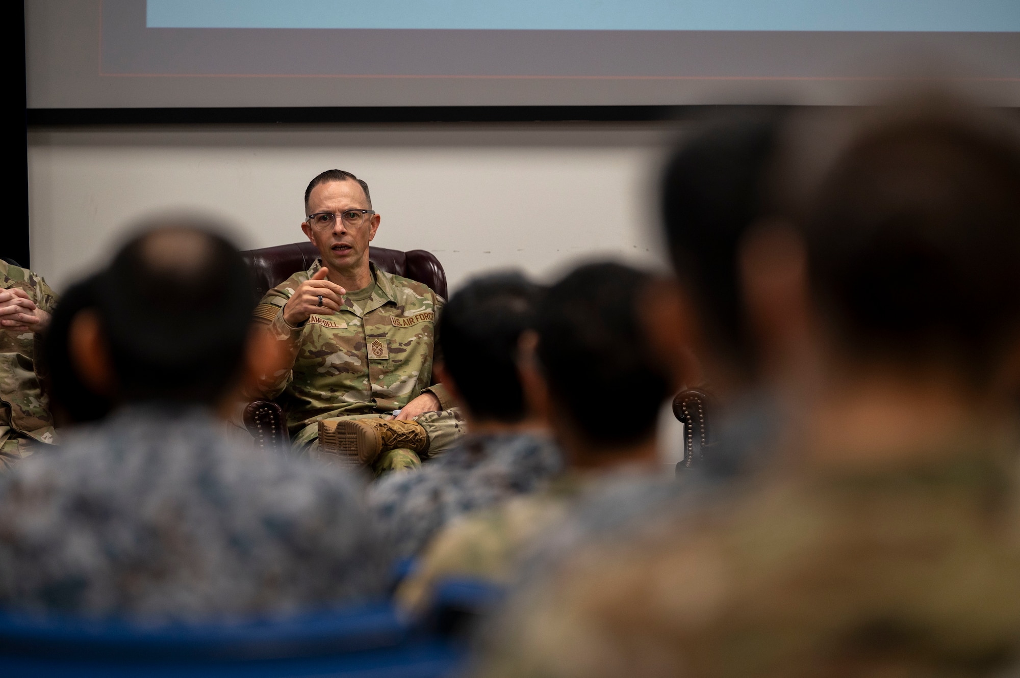 A U.S. military member speaks to a group of JASDF and U.S. military members.