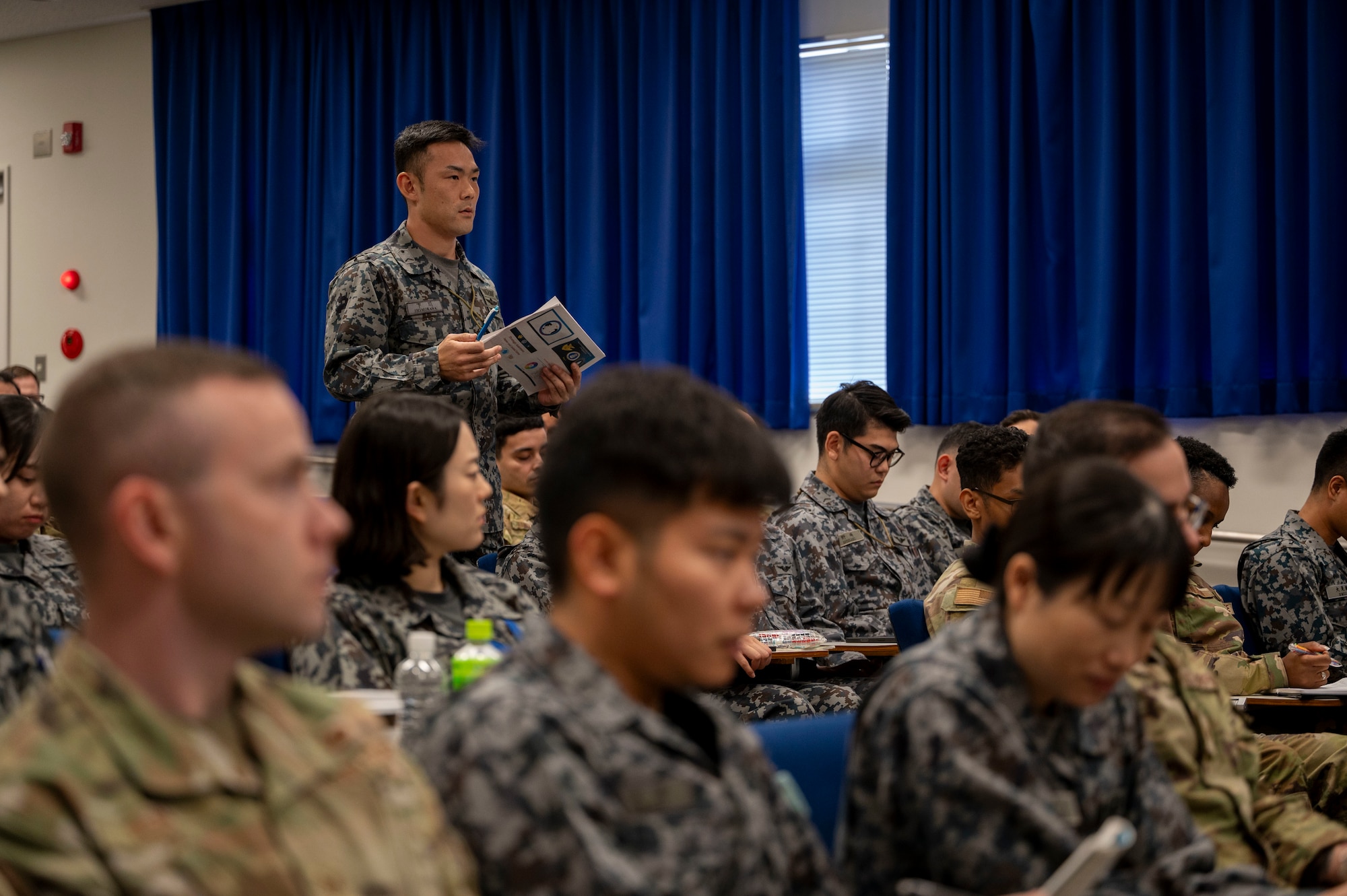 A JASDF member stands to ask a question.