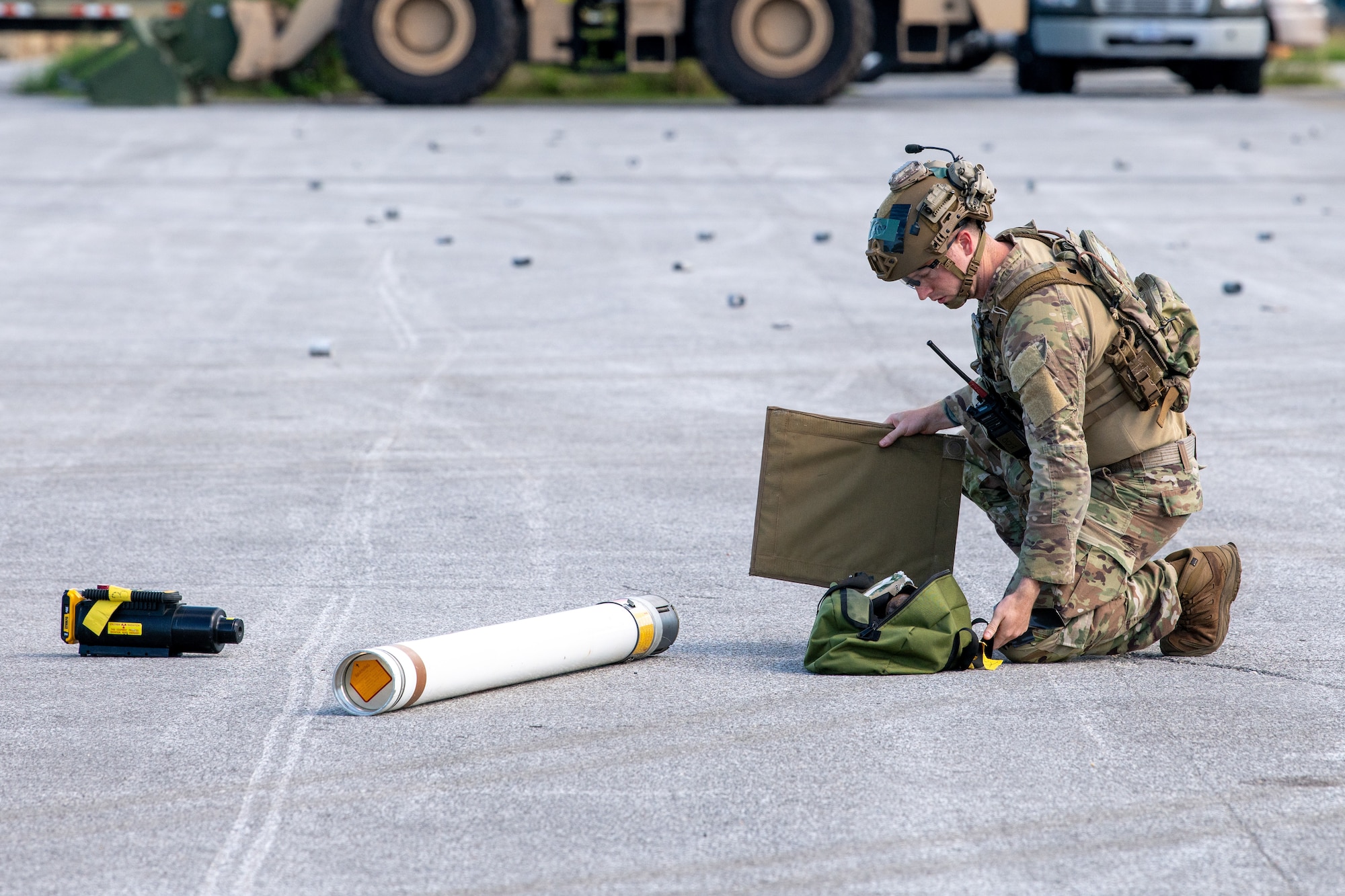 U.S. Air Force Tech. Sgt. Michael Carter, 18th Civil Engineer Squadron explosive ordnance disposal technician, removes a simulated unexploded ordnance in support of base-wide readiness exercise BH 26-1 at Kadena Air Base, Japan, Nov. 6, 2025. EOD technicians provide explosive threat mitigation to safely render potential threats inert. (U.S. Air Force photo by Airman 1st Class Francisco Huerta)