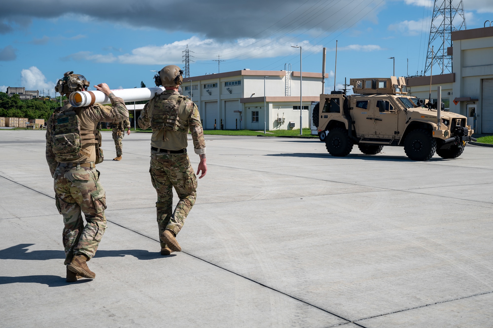 U.S. Air Force explosive ordnance disposal technicians assigned to the 18th Civil Engineer Squadron transport a simulated unexploded ordinance round that has been disarmed during base-wide readiness exercise BH 26-1 at Kadena Air Base, Japan, Nov. 6, 2025. Removing UXOs is one of the first steps in rapid airfield damage repair, and is essential to regenerating combat airpower quickly and safely. (U.S. Air Force photo by Airman 1st Class Francisco Huerta)