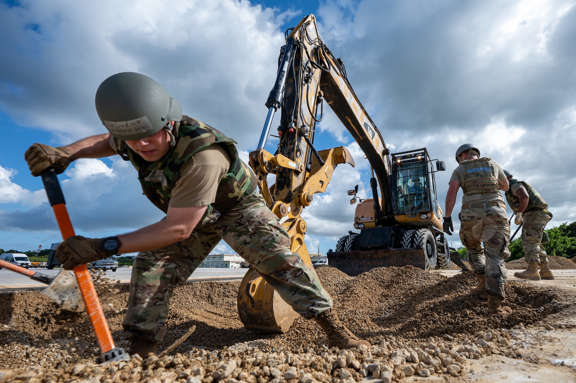 U.S. Air Force Airmen from the 18th Civil Engineer Squadron clear a simulated damaged area in preparation for repair during rapid airfield damage repair training during base-wide readiness exercise BH 26-1 at Kadena Air Base, Japan, Nov. 6, 2025. RADR exercises enhance future operations by improving team coordination and identifying areas for process improvement across all civil engineer shops. (U.S. Air Force Photo by Airman 1st class Francisco Huerta)