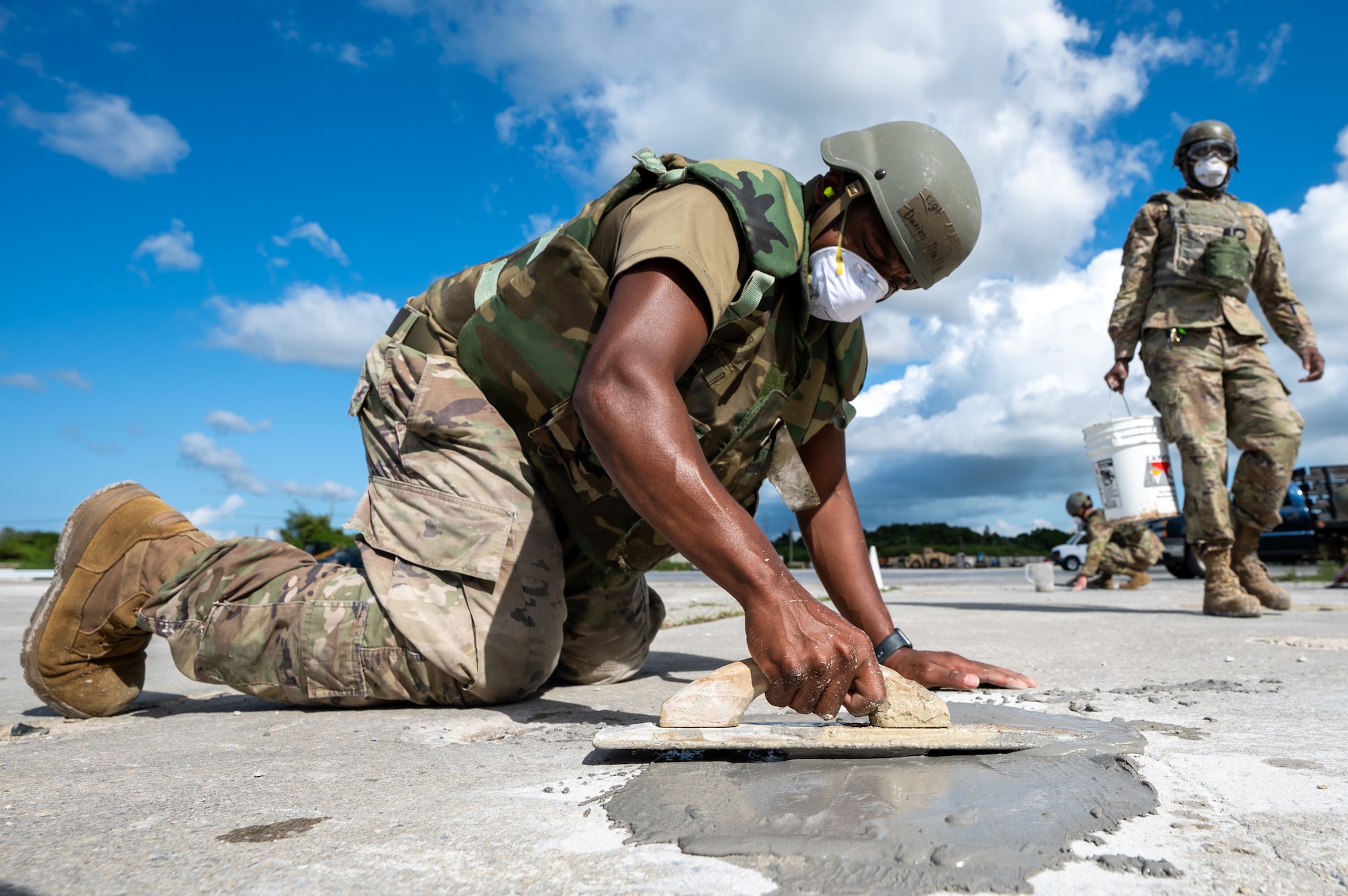 U.S. Air Force SSgt Davion Bradley, 18th Civil Engineer Squadron HVAC journeyman, center,  repairs a simulated crater during rapid airfield damage repair training in support of base-wide readiness exercise BH 26-1 at Kadena Air Base, Japan, Nov. 6, 2025. Large-scale readiness exercises like BH 26-1 provide Kadena with valuable opportunities to refine coordination, communication, and mission execution in dynamic, high-stress environments. (U.S. Air Force Photo by Airman 1st class Francisco Huerta)
