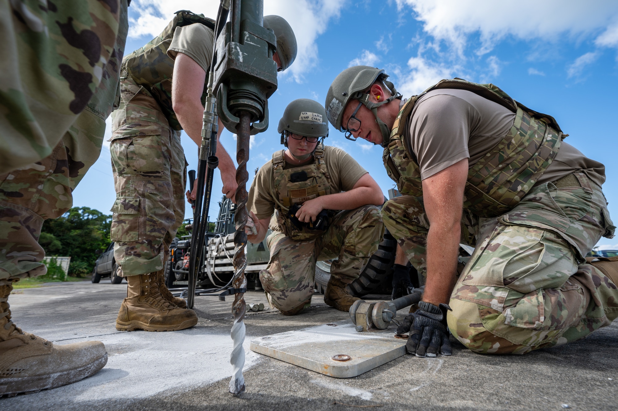 U.S. Air Force Airmen from the 18th Civil Engineer Squadron install the mobile aircraft arresting system after a simulated air strike during base-wide readiness exercise BH 26-1 at Kadena Air Base, Japan, Nov. 6, 2025. A MAAS is a rapid installation emergency system used to recover fighter aircraft returning to and launching from a battle-damaged airfield. (U.S. Air Force photo by Airman 1st Class Francisco Huerta)