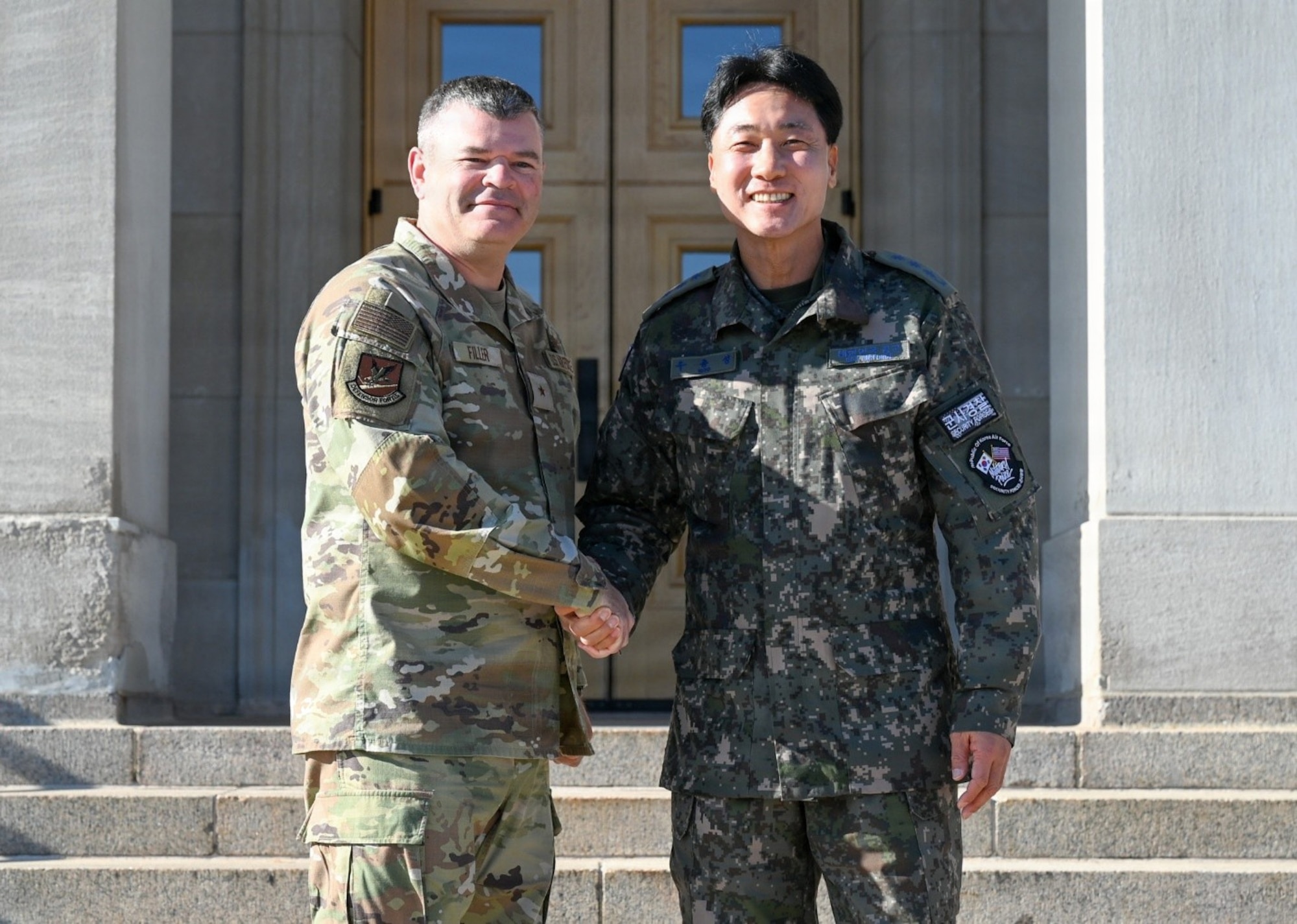 U.S. Air Force Brig. Gen. Brian A. Filler, Director of Security Forces, Deputy Chief of Staff for Logistics, Engineering and Force Protection, poses with Republic of Korea Air Force Col. Jongsung Woo, during a visit to the Pentagon.