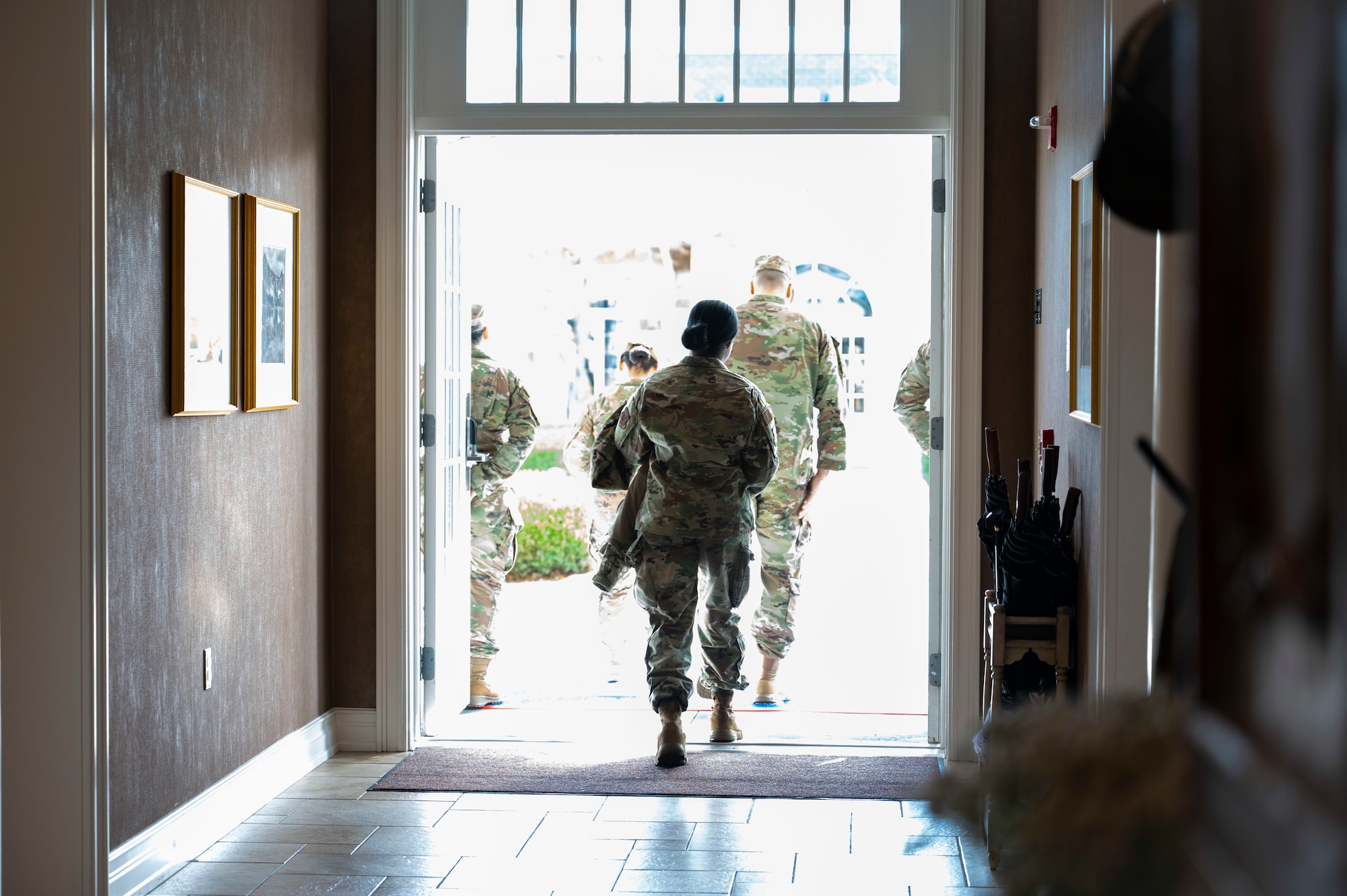 U.S. Air Force Capt. Tamikka Williams, Air Force Mortuary Affairs Operations operations division chief, departs the Dover Fisher House for Families of the Fallen, Dover Air Force Base, Delaware, Nov. 18, 2025. The Fisher House for Families of the Fallen at Dover Air Force Base, Delaware, is a unique facility among the Fisher House Foundation's other locations. It is the only one of its kind, designed for families of the fallen and managed exclusively by uniformed personnel. It is designed to provide short-term, on-base lodging to families who travel to Dover AFB to witness the dignified transfer of their loved one. (U.S. Air Force photo by Staff Sgt. Frank Rohrig)
