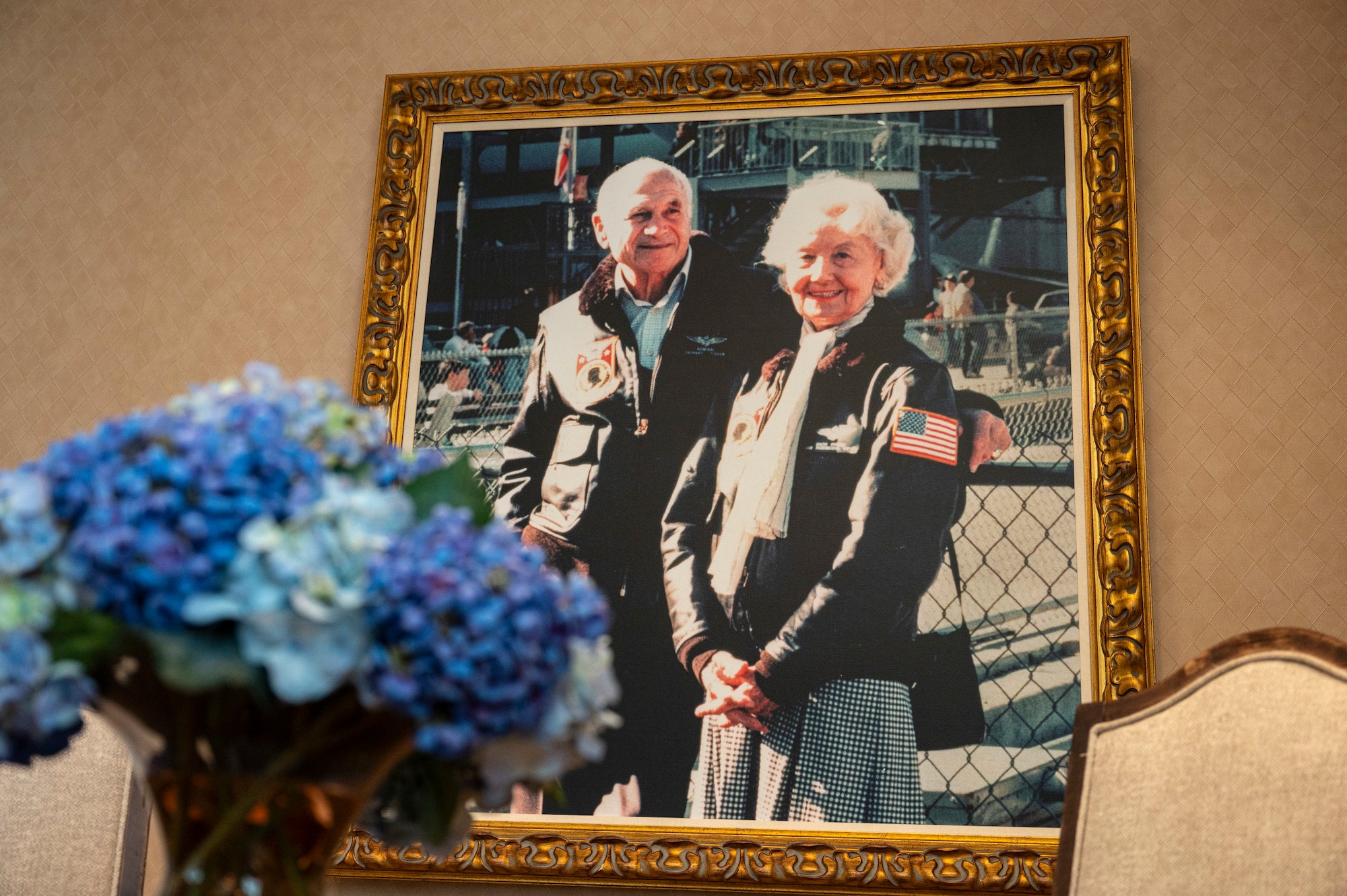 A framed photo of Zachary and Elizabeth Fisher, Founders of the Fisher House Foundation, displayed inside of the Dover Fisher House for Families of the Fallen, Dover Air Force Base, Delaware, Nov. 18 2025. Identified by the Fisher Foundation as a complement to the Center for Families of the Fallen, the Fisher House for Families of the Fallen is the 50th house within the Fisher family of homes. The House was gifted to the Air Force and dedicated Nov. 10, 2010. (U.S. Air Force photo by Staff Sgt. Frank Rohrig)