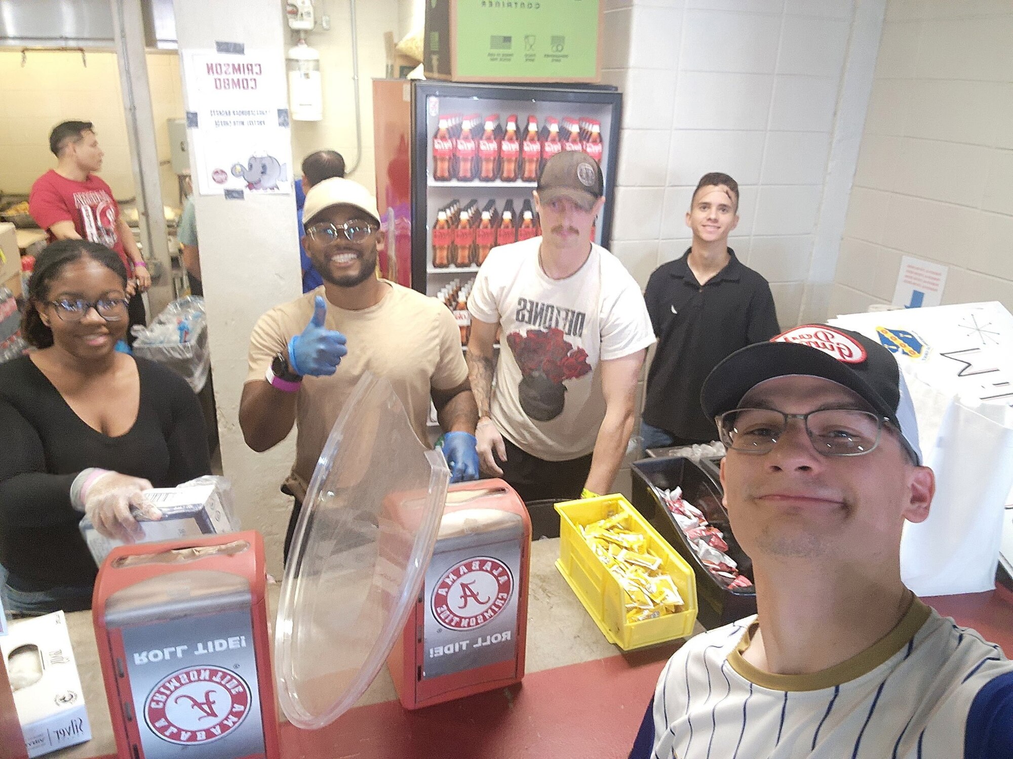 U.S. Air Force members from the 42d Wing Staff Agency Booster Club volunteer serving food at Saban Field at Bryant-Denny Stadium, Oct. 17, 2025.