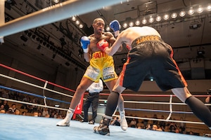 U.S. Air Force Senior Airman Craig Jeudy, Fifth Air Force technical support technician, receives a hit during the East-Japan Newcomer King tournament semifinal.