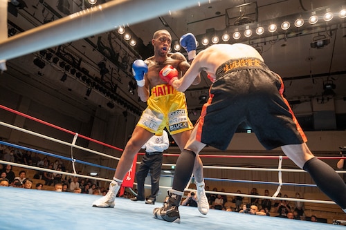 U.S. Air Force Senior Airman Craig Jeudy, Fifth Air Force technical support technician, receives a hit during the East-Japan Newcomer King tournament semifinal.