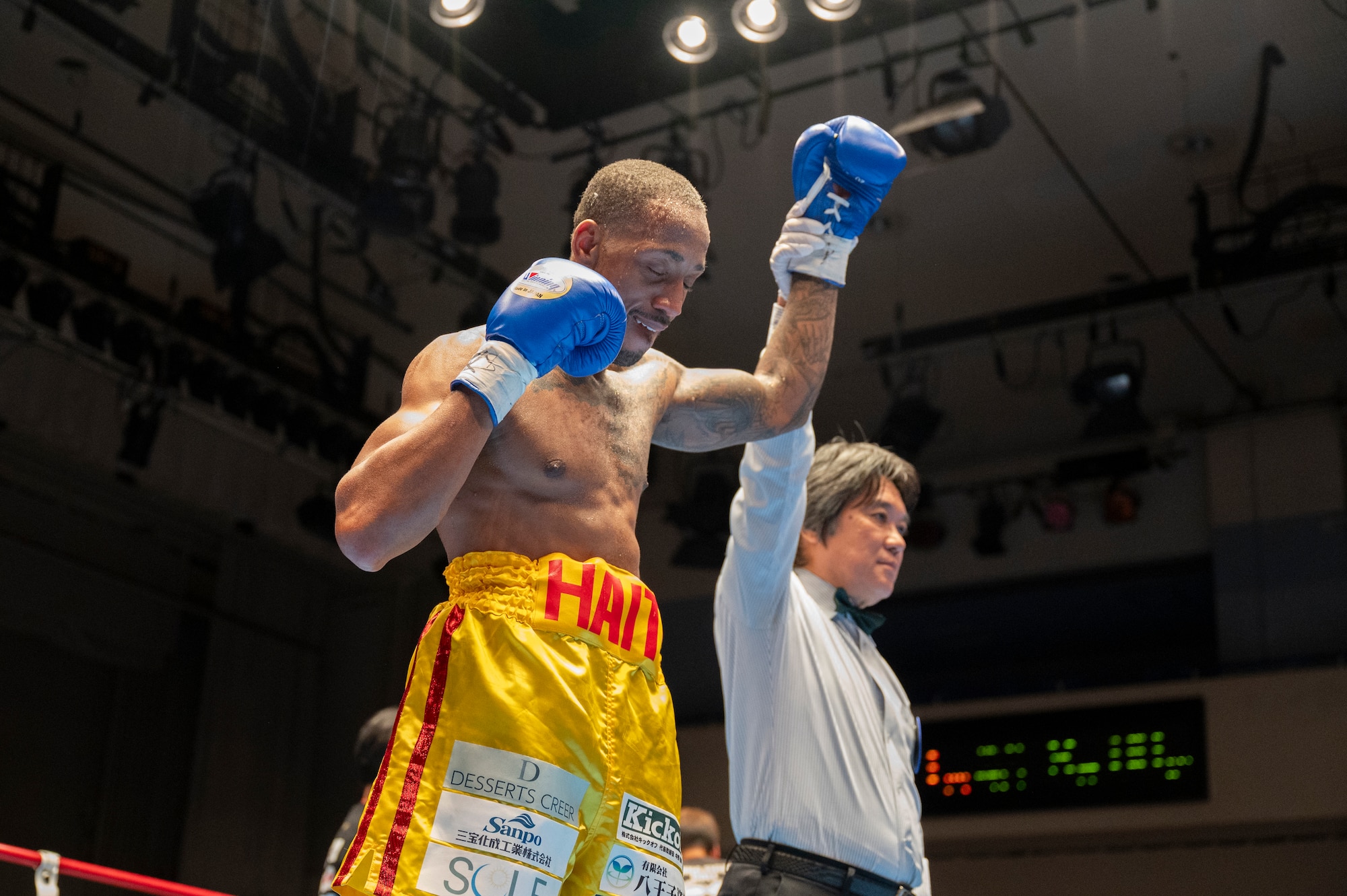 U.S. Air Force Senior Airman Craig Jeudy, Fifth Air Force technical support technician, raises his glove as he is announced as winner of his East-Japan Newcomer King tournament semifinal fight.