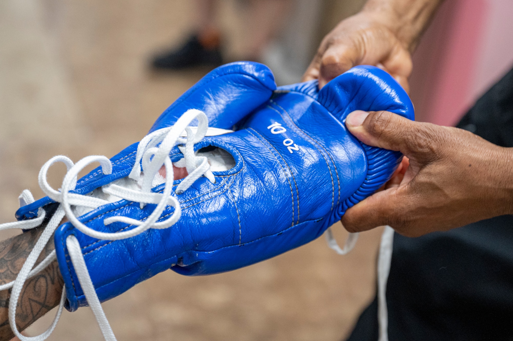 Rick Yoshimura removes a glove from the hands of U.S. Air Force Senior Airman Craig Jeudy, Fifth Air Force technical support technician.