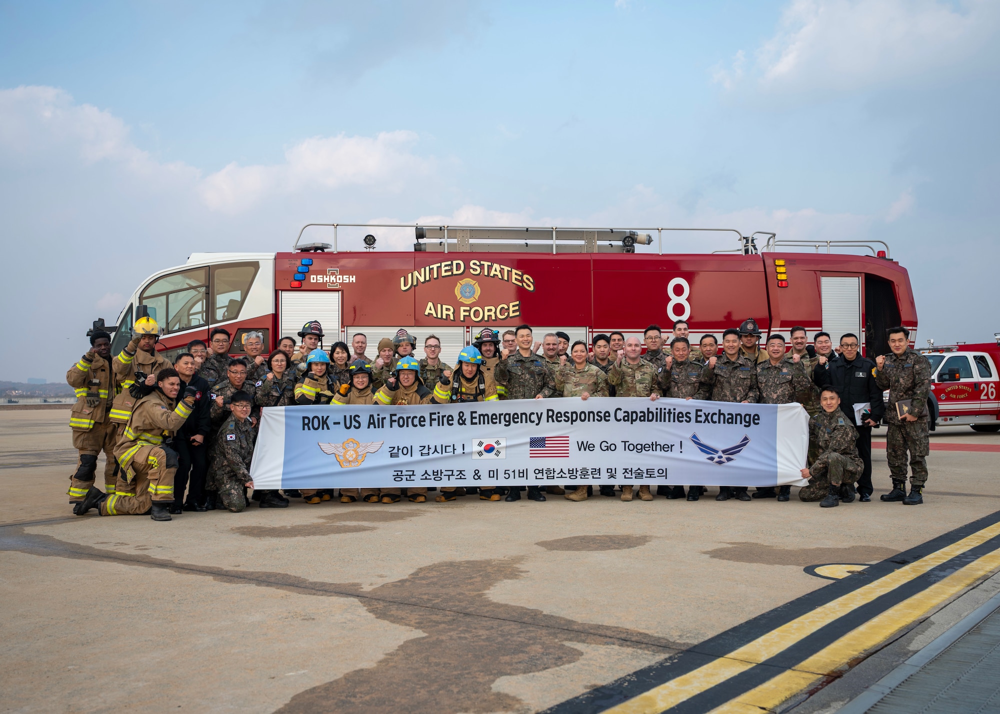 Firefighters from the 51st Civil Engineer Squadron and Republic of Korea Air Force pose for a group photo at Osan Air Base, Republic of Korea, Nov. 20, 2025. More than 20 members of the ROKAF fire department participated in the joint training, working hand in hand with their U.S. Air Force counterparts to strengthen interoperability, enhance emergency response skills and reinforce strategic partnerships. (U.S. Air Force photo by Staff Sgt. Sarah Williams)