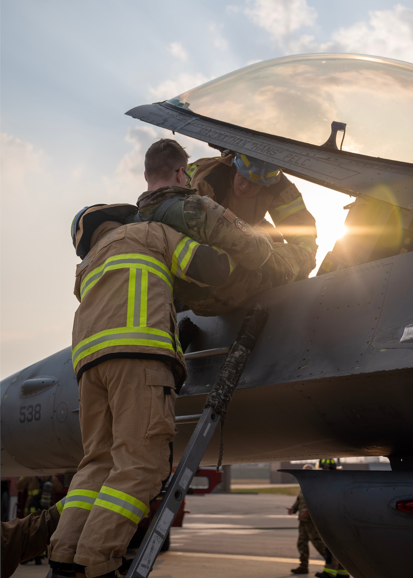 Republic of Korea Air Force firefighters perform a pilot egress during a joint training event at Osan Air Base, Republic of Korea, Nov. 20, 2025. U.S. and ROKAF firefighters participated in a series of events including an equipment display, mission brief, fire station tour, joint physical training, an F-16 Fighting Falcon pilot rescue exercise, and a 1410 hose deployment drill.  (U.S. Air Force photo by Staff Sgt. Sarah Williams)