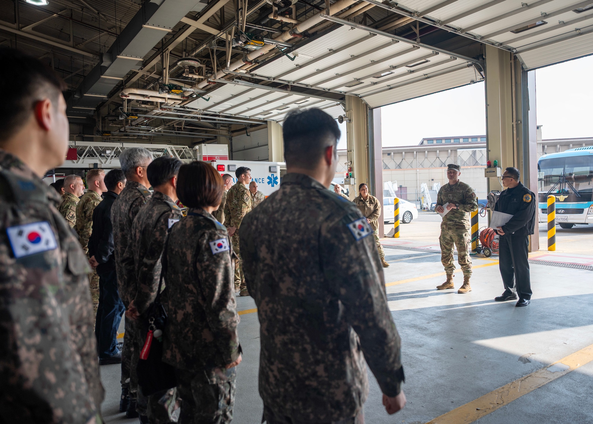 U.S. Air Force Col. Jeffrey Elliott, center right, 51st Mission Support Group commander, gives opening remarks at Osan Air Base, Republic of Korea, Nov. 20, 2025. The training provided an opportunity for U.S. Air Force and ROK Air Force fire departments to strengthen their ability to respond jointly to emergencies, advancing a shared priority of safeguarding and protecting Osan Air Base. (U.S. Air Force photo by Staff Sgt. Sarah Williams)