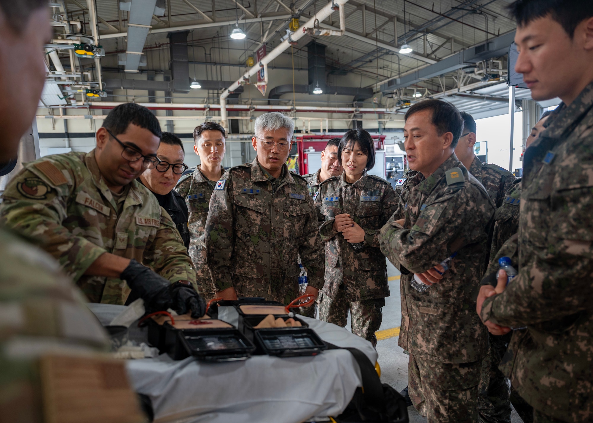 Members of the Republic of Korea Air Force fire department observe a wound packing demonstration by a 51st Civil Engineer Squadron firefighter at Osan Air Base, Republic of Korea, Nov. 20, 2025. The training provided an opportunity for U.S. Air Force and ROK Air Force fire departments to strengthen their ability to respond jointly to emergencies, advancing a shared priority of safeguarding and protecting Osan Air Base. (U.S. Air Force photo by Staff Sgt. Sarah Williams)