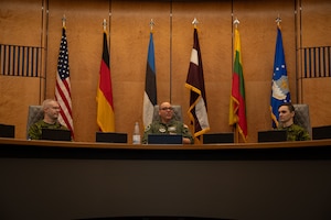 U.S. Air Force Col. Ryan Ferdinandsen, middle, U.S. Air Forces in Europe - Air Forces Africa deputy director of plans and programs, speaks to Baltic nation service members at the USAFE-AFAFRICA Headquarters at Ramstein Air Base, Germany, Nov. 25, 2025.