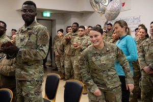 U.S. Air Force Tech. Sgt. Kaycie Davis, 86th Medical Group dental assistant, walks to the front to receive notification of her promotion under the Air Force’s Stripes for Exceptional Performers program, Nov. 25, 2025, at Ramstein Air Base, Germany.