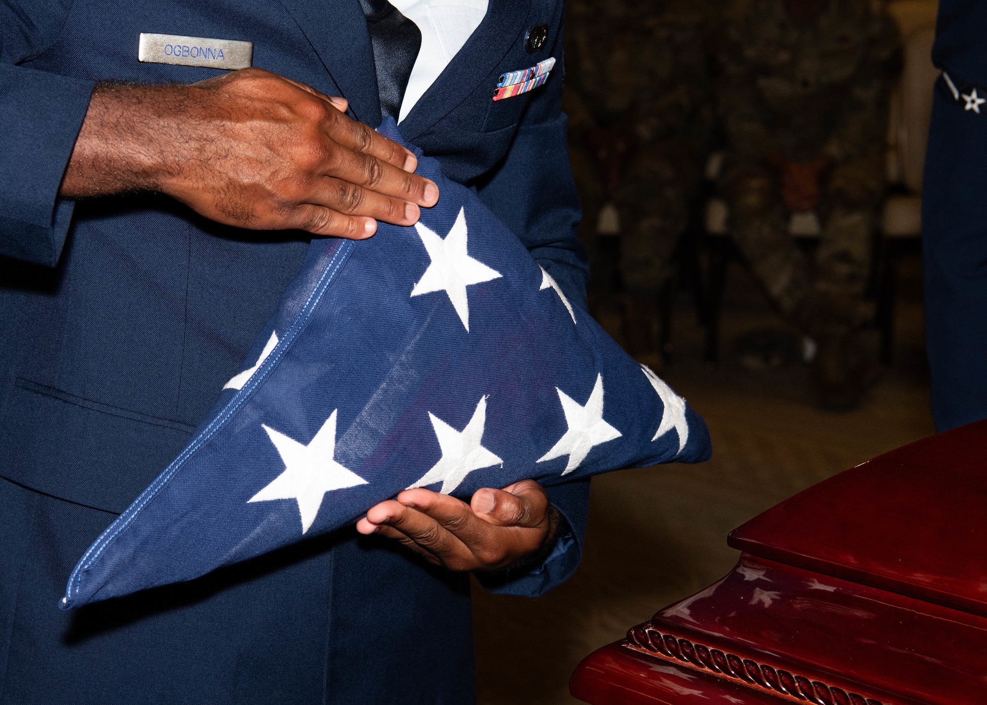 A photo of an Airman holding the U.S. flag.