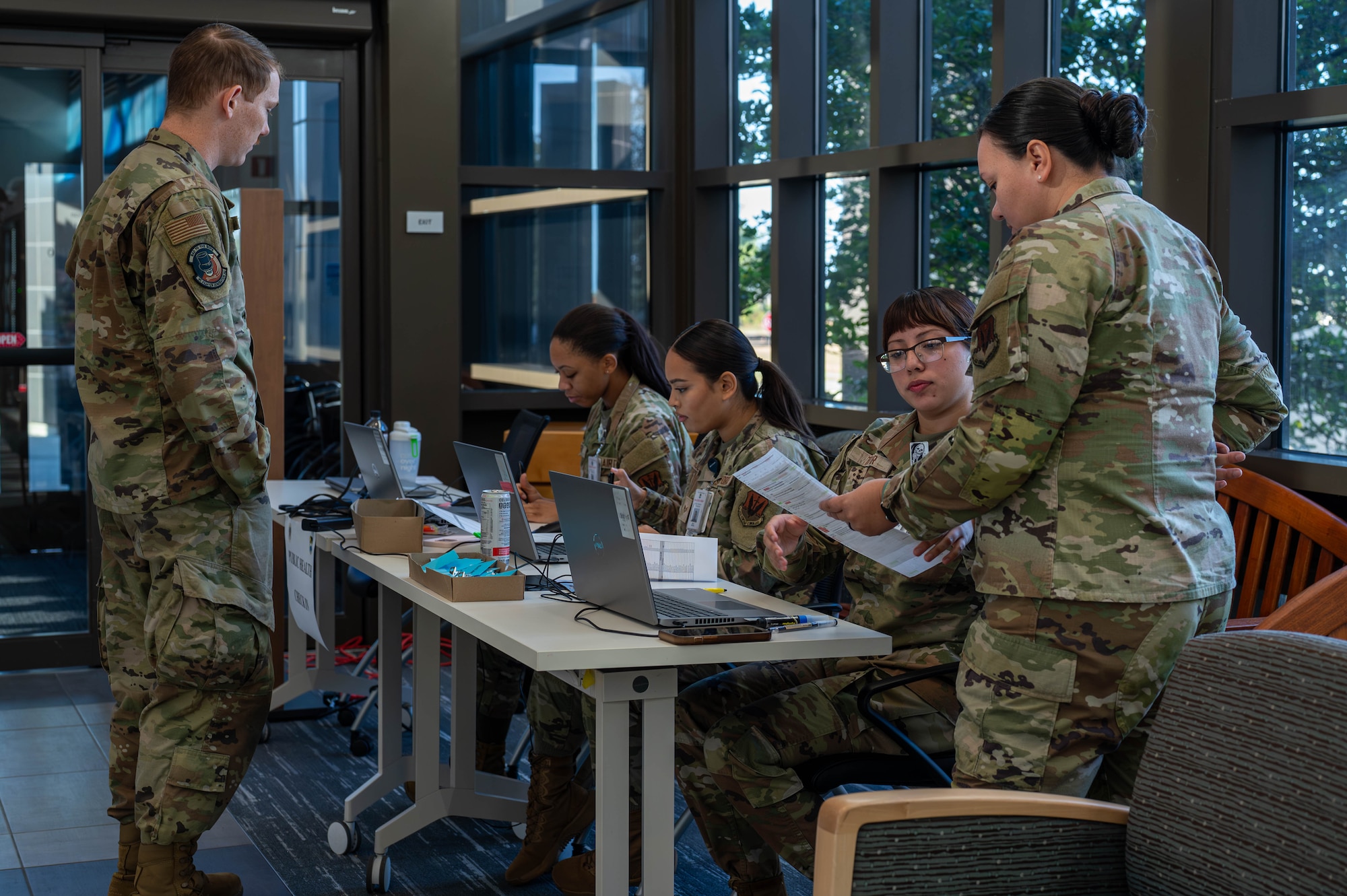 U.S. Airmen assigned to the 325th Operational Medical Readiness Squadron guide deploying Airmen through a Personnel Deployment Function line at Tyndall Air Force Base.